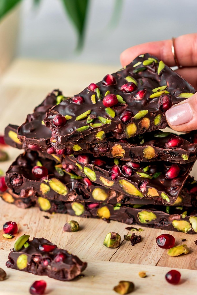 3-Ingredient Vegan Chocolate Bark with pomegranate and pistachio Stacked on top of each other