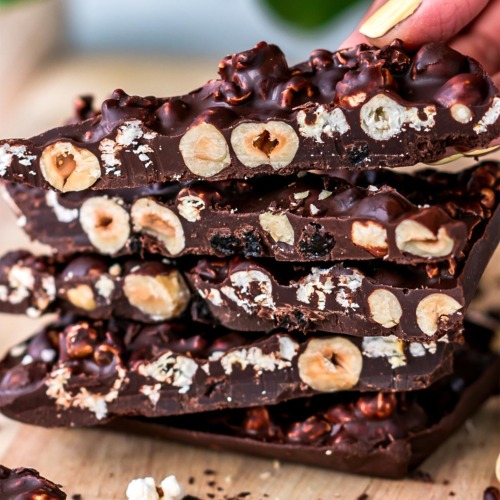 3-Ingredient Vegan Dark Chocolate Bark with Popcorn and Hazelnut stacked on top of each other